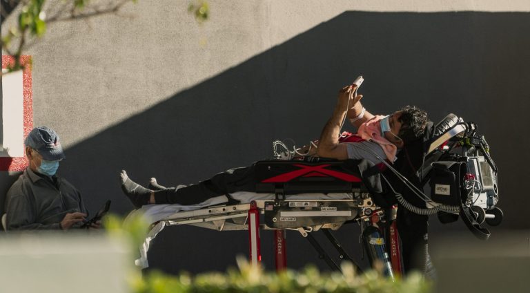 Hospitals try to keep pace, stores close during virus surge