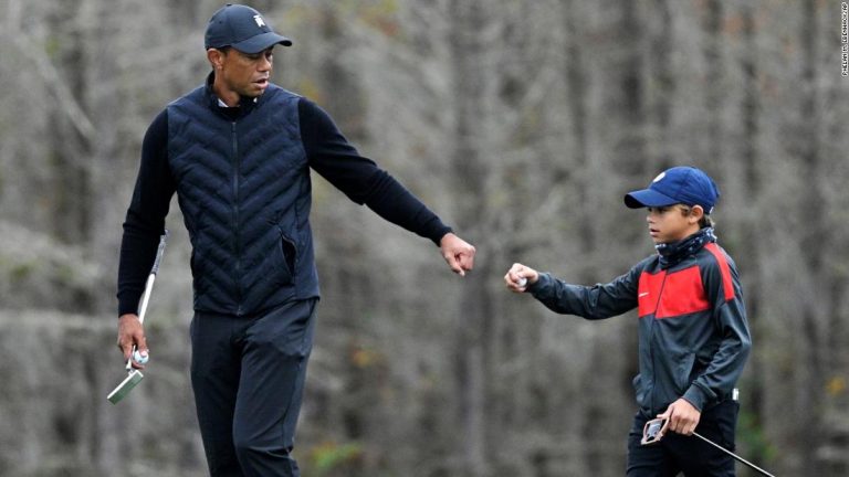 Tiger Woods warms up with his son Charlie, 11, and the similarities are striking