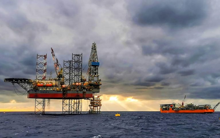 Oil climbs to 13-month high on output cuts, weaker dollar