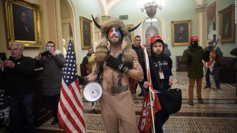 ‘QAnon shaman’ must remain in jail, judge rules