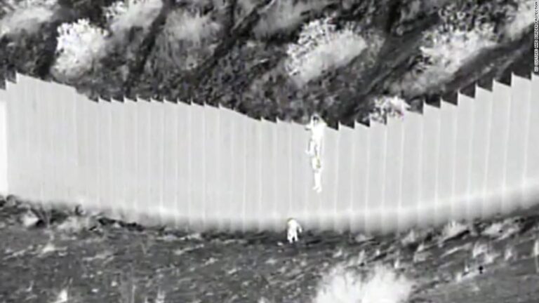 Video shows young children being dropped over 14-foot border fence into the US