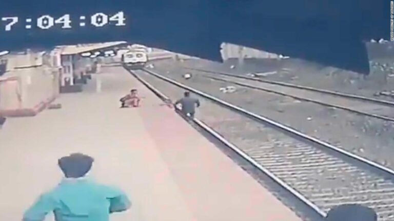 CCTV shows the moment a railroad worker snatched a child from the path of a train