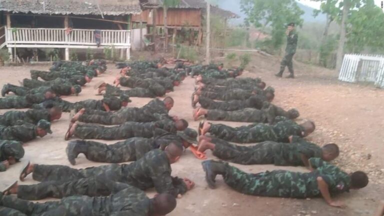 At military camps in the Myanmar jungle, doctors and students learn how to fire guns