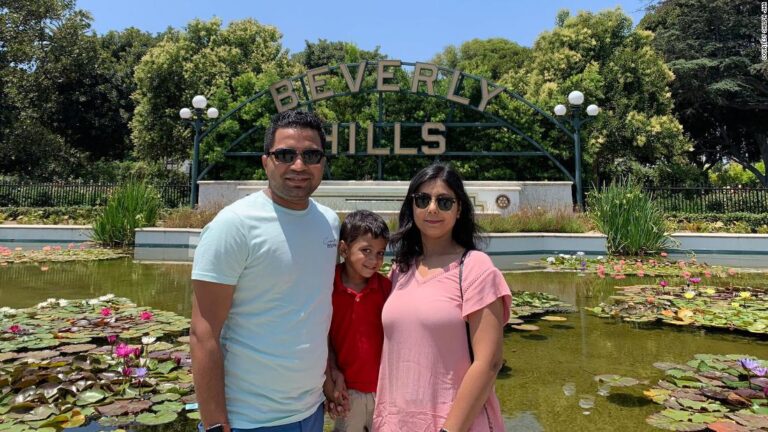 He flew to India to see his parents sick with Covid. Now he’s unable to get back to his pregnant wife