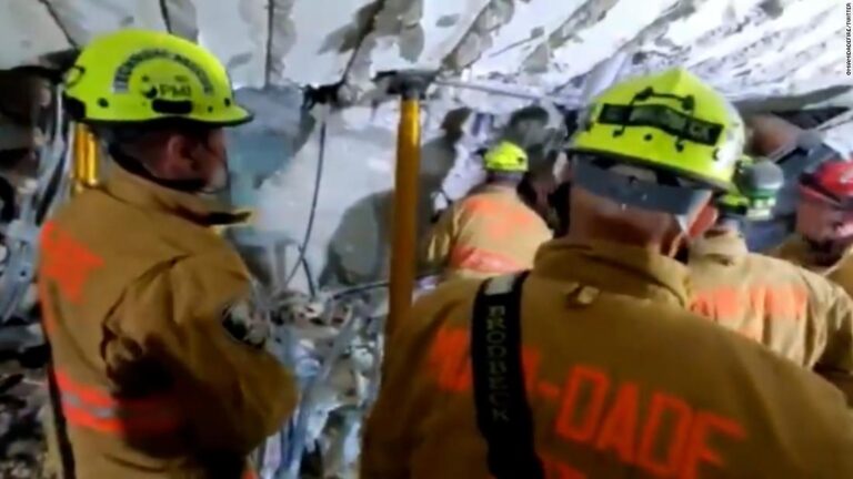 Video shows rescuers working to find people trapped under rubble
