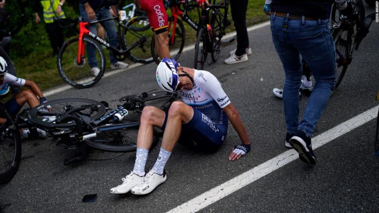 Fan holding sign causes huge crash during first stage of Tour de France