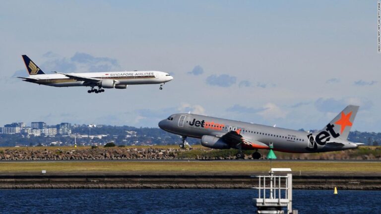 Australian government halves arrival cap, leaving thousands stranded