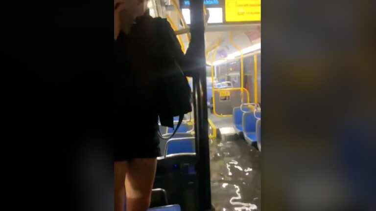 Floodwaters force bus riders to stand on seats