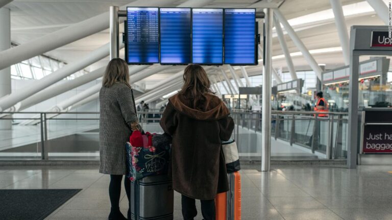 Covid causes travel chaos, as US airlines cancel hundreds of flights on one of the busiest days of the year
