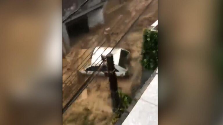 Dramatic footage shows flood carrying car after torrential rain