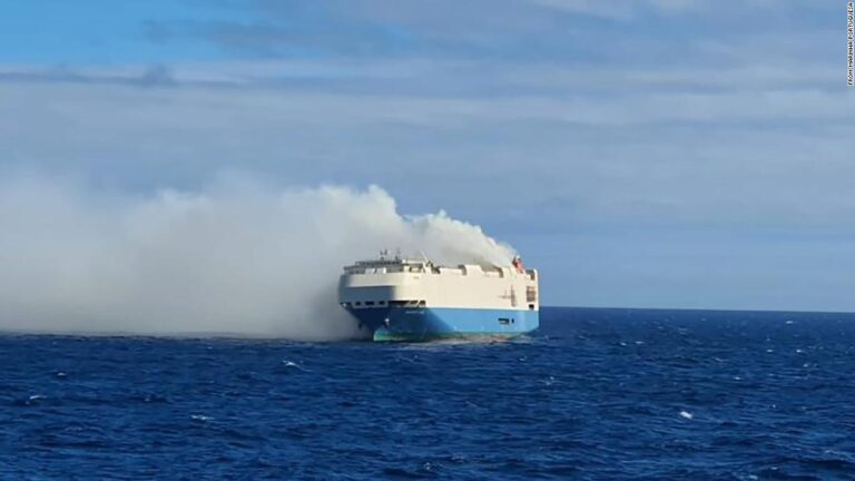 Cargo ship full of luxury cars on fire, adrift in the ocean