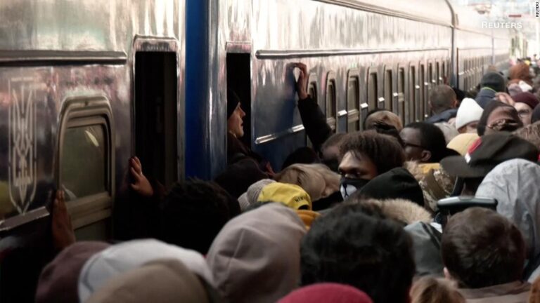 Soldiers fire warning shots to control crowd at Ukraine train station