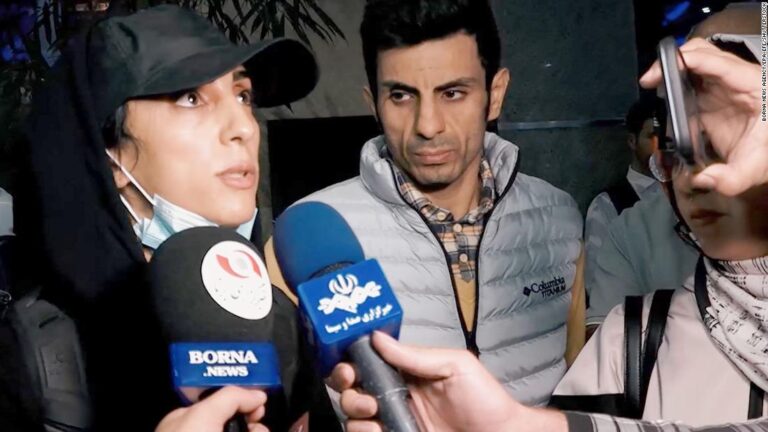 Iranian rock climber arrives back in Tehran after competing without hijab