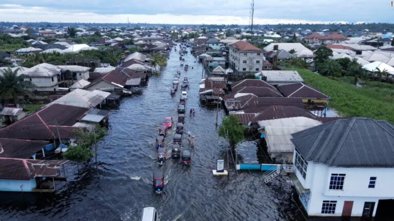 CNN reporter interviews survivor while standing in floodwater